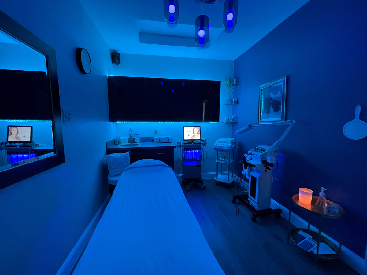 View of a procedure room at Chameleon Medspa with a blue light on