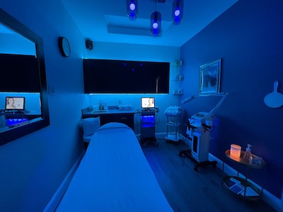 Inviting room with blue lights, laser treatment devices and a bed